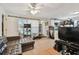 This is a cozy living room featuring a comfortable sectional sofa, with tile flooring and natural light at 361 Colonial Ct, Dunedin, FL 34698
