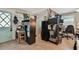 Featuring a functional office space with shelving units, a workstation, and natural light at 361 Colonial Ct, Dunedin, FL 34698