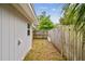 Side yard area with wood fence offering privacy at 361 Colonial Ct, Dunedin, FL 34698