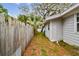 This home includes a side yard area with ample space and privacy fence at 361 Colonial Ct, Dunedin, FL 34698