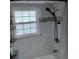 Bathroom features a modern shower head and a window with natural light at 3850 13Th N Ave # 311, St Petersburg, FL 33713