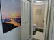Bathroom entrance near closet with wall art and neutral paint colors at 3850 13Th N Ave # 311, St Petersburg, FL 33713