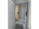 Hallway with closet leading to a brightly lit entry door with a rug at 3850 13Th N Ave # 311, St Petersburg, FL 33713