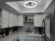 A well-lit kitchen area with white cabinets, a tiled backsplash, and stainless steel refrigerator at 3850 13Th N Ave # 311, St Petersburg, FL 33713