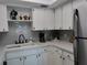 Bright kitchen featuring white cabinets, stainless steel appliances, and a tiled backsplash at 3850 13Th N Ave # 311, St Petersburg, FL 33713