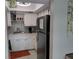 Well-lit kitchen with white cabinetry, stainless steel refrigerator, and tiled backsplash at 3850 13Th N Ave # 311, St Petersburg, FL 33713