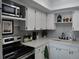 Kitchen features a microwave, oven, and ample countertop space with a tile backsplash at 3850 13Th N Ave # 311, St Petersburg, FL 33713