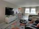 Comfortable living room with plush seating, a large TV, and lots of natural light at 3850 13Th N Ave # 311, St Petersburg, FL 33713