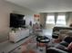 Comfortable living room with plush seating, a large TV, and lots of natural light at 3850 13Th N Ave # 311, St Petersburg, FL 33713