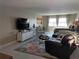 Spacious living room showcasing modern furniture, a large TV, and an open floor plan at 3850 13Th N Ave # 311, St Petersburg, FL 33713