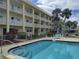 Inviting community pool with comfortable lounge chairs and meticulously maintained landscaping at 3850 13Th N Ave # 311, St Petersburg, FL 33713