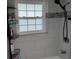 Bathroom featuring shower with tiled walls, shower head, and shower caddy for toiletries at 3850 13Th N Ave # 311, St Petersburg, FL 33713