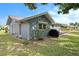 Exterior home view highlighting the backyard, grill, and screened-in patio at 4326 Great Lakes N Dr, Clearwater, FL 33762