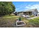 Wide backyard featuring a bird bath, small garden and the house screened in patio at 4326 Great Lakes N Dr, Clearwater, FL 33762