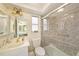Bathroom with a glass-enclosed shower, a white vanity, and a view into the adjoining bathroom at 4326 Great Lakes N Dr, Clearwater, FL 33762