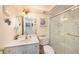 Well-lit bathroom featuring a glass-enclosed shower, white vanity, and modern fixtures at 4326 Great Lakes N Dr, Clearwater, FL 33762