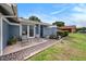 Charming exterior featuring a front patio with chairs, mosaic tile, and flower garden at 4326 Great Lakes N Dr, Clearwater, FL 33762