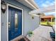 Close-up of the front door showing the beautiful glass features, hardware, and a glimpse of the walkway at 4326 Great Lakes N Dr, Clearwater, FL 33762