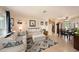 Spacious living room featuring tile floors, comfortable seating, and an open layout connected to the dining area at 4326 Great Lakes N Dr, Clearwater, FL 33762