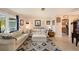 Bright living room with tile flooring, white sofas, and seamless flow to the dining area, perfect for gatherings at 4326 Great Lakes N Dr, Clearwater, FL 33762