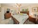 Comfortable main bedroom with a queen bed, coordinating furniture, tile floors, and lots of natural light at 4326 Great Lakes N Dr, Clearwater, FL 33762
