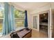 Relaxing sunroom featuring tile floors, sliding glass doors, and a bench seat, offering views of the backyard at 4326 Great Lakes N Dr, Clearwater, FL 33762