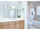 Neat bathroom with a single sink vanity, a large mirror, and a shower-tub combination at 4968 Anniston Cir, Tampa, FL 33647
