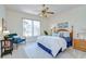 Well-lit bedroom features a ceiling fan, large window with blinds, and neutral decor at 4968 Anniston Cir, Tampa, FL 33647
