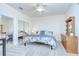 Bright bedroom featuring plush carpet, ceiling fan, and mirrored closet doors at 4968 Anniston Cir, Tampa, FL 33647