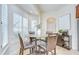 Cozy breakfast nook area features bright natural light and a glass-top dining table with seating for four at 4968 Anniston Cir, Tampa, FL 33647