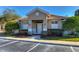Clubhouse exterior showcasing the entrance, landscaping, and guest parking spaces at 4968 Anniston Cir, Tampa, FL 33647