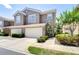 Two-story townhome featuring a two-car garage and well-maintained landscaping at 4968 Anniston Cir, Tampa, FL 33647