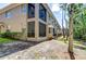 Exterior view of the townhome featuring screened-in lanais and lush greenery at 4968 Anniston Cir, Tampa, FL 33647