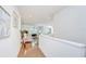 Inviting hallway with hardwood floors leading to the living room at 4968 Anniston Cir, Tampa, FL 33647