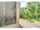Relaxing screened-in lanai with wooded views at 4968 Anniston Cir, Tampa, FL 33647