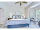 Serene main bedroom with a ceiling fan, plush carpet, and a bay window seating area at 4968 Anniston Cir, Tampa, FL 33647