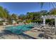Community pool area featuring clear water, lounge chairs, and a shaded pergola at 4968 Anniston Cir, Tampa, FL 33647