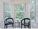 Relaxing sitting area with two comfortable chairs and scenic outdoor views through large windows at 4968 Anniston Cir, Tampa, FL 33647