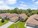This house shows off its manicured green lawn and landscaping in this attractive aerial view at 521 Bent Oak Ct, Spring Hill, FL 34609