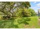 Secluded backyard with mature trees and lush greenery providing a tranquil outdoor space at 521 Bent Oak Ct, Spring Hill, FL 34609