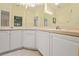 Bathroom featuring a large mirror, vanity, and cabinets, with ample lighting at 521 Bent Oak Ct, Spring Hill, FL 34609