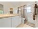 Well-lit bathroom featuring a vanity with sink, a large mirror, and a shower-tub combo at 521 Bent Oak Ct, Spring Hill, FL 34609