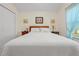Comfortable bedroom featuring a queen bed, neutral decor, and natural light from the window at 521 Bent Oak Ct, Spring Hill, FL 34609