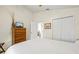 Cozy bedroom with a dresser, TV, and access to an ensuite bathroom at 521 Bent Oak Ct, Spring Hill, FL 34609