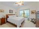 Bright bedroom with a ceiling fan, large window, and warm, inviting natural light at 521 Bent Oak Ct, Spring Hill, FL 34609