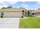 Charming single-story home with a two-car garage and well-manicured lawn at 521 Bent Oak Ct, Spring Hill, FL 34609