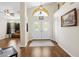 Elegant foyer showcasing double doors, hardwood floors, and lots of natural light at 521 Bent Oak Ct, Spring Hill, FL 34609