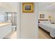 Hallway view of a bedroom and a bathroom, creating a sense of space and flow at 521 Bent Oak Ct, Spring Hill, FL 34609