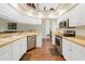 Modern kitchen features white cabinets, stainless appliances, and vinyl flooring throughout at 521 Bent Oak Ct, Spring Hill, FL 34609