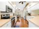 Modern kitchen featuring white cabinets, stainless steel appliances, and adjacent dining area at 521 Bent Oak Ct, Spring Hill, FL 34609